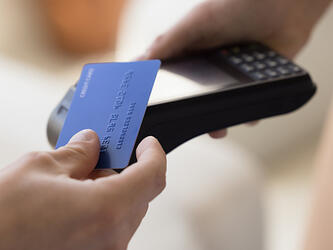 Person using card in a shop